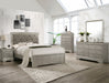 Silver bedroom furniture set with headboard, bed, nightstands, and dresser in a bright room.