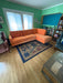 Custom Orange Talmadge sectional by Flores Design featuring blue fabric upholstery and curved corner configuration, available at Sacramento Furniture Store.