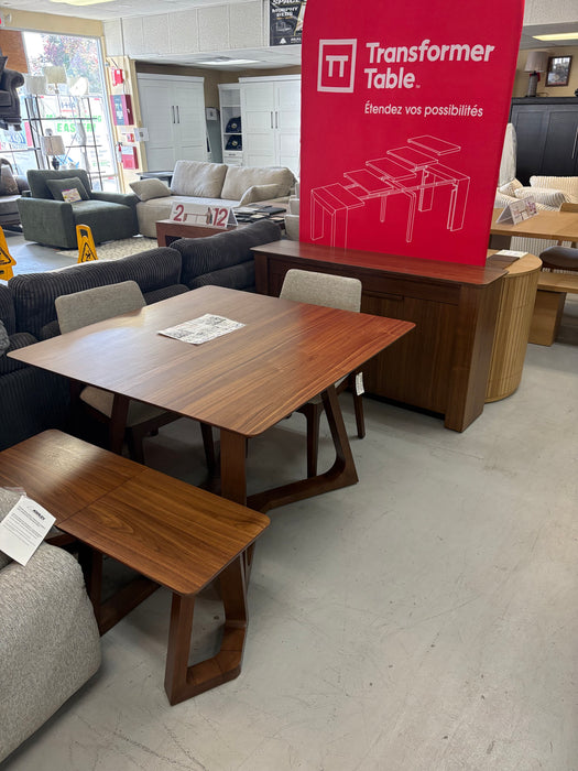 Transformer Nova expandable dining table with matching bench and chairs on display at Sacramento Furniture Store