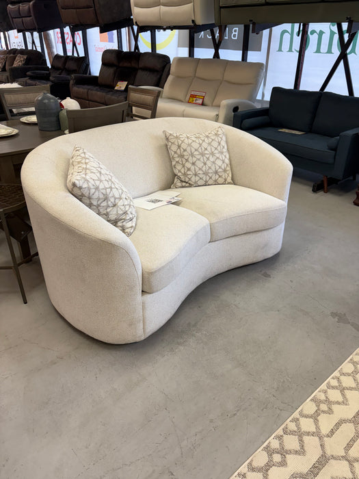 Modern latte bouclé loveseat with plush cushions and curved arms at our Sacramento furniture outlet.