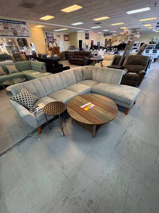 Mid-century modern light gray sectional with vertical tufting and angled wood legs at our Sacramento furniture outlet.